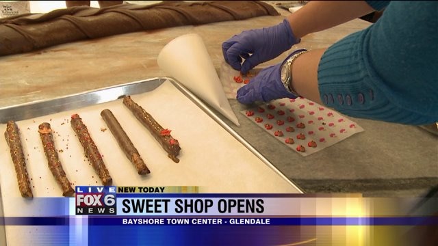 Laura helps make pretzels dipped in chocolate