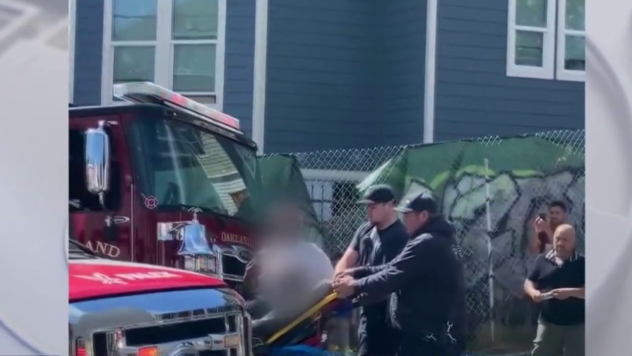 Man wheeled on gurney after Oakland shootout