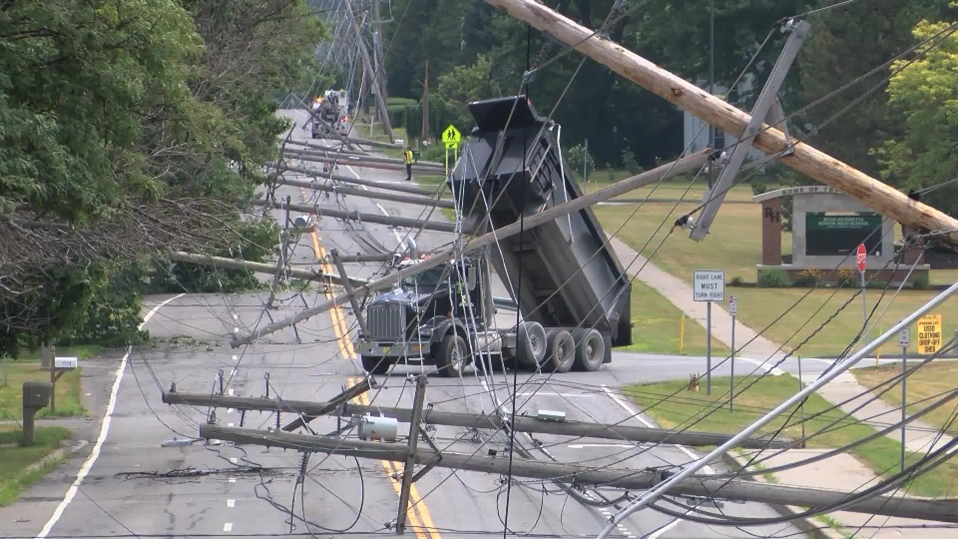 Dump truck topples utility poles