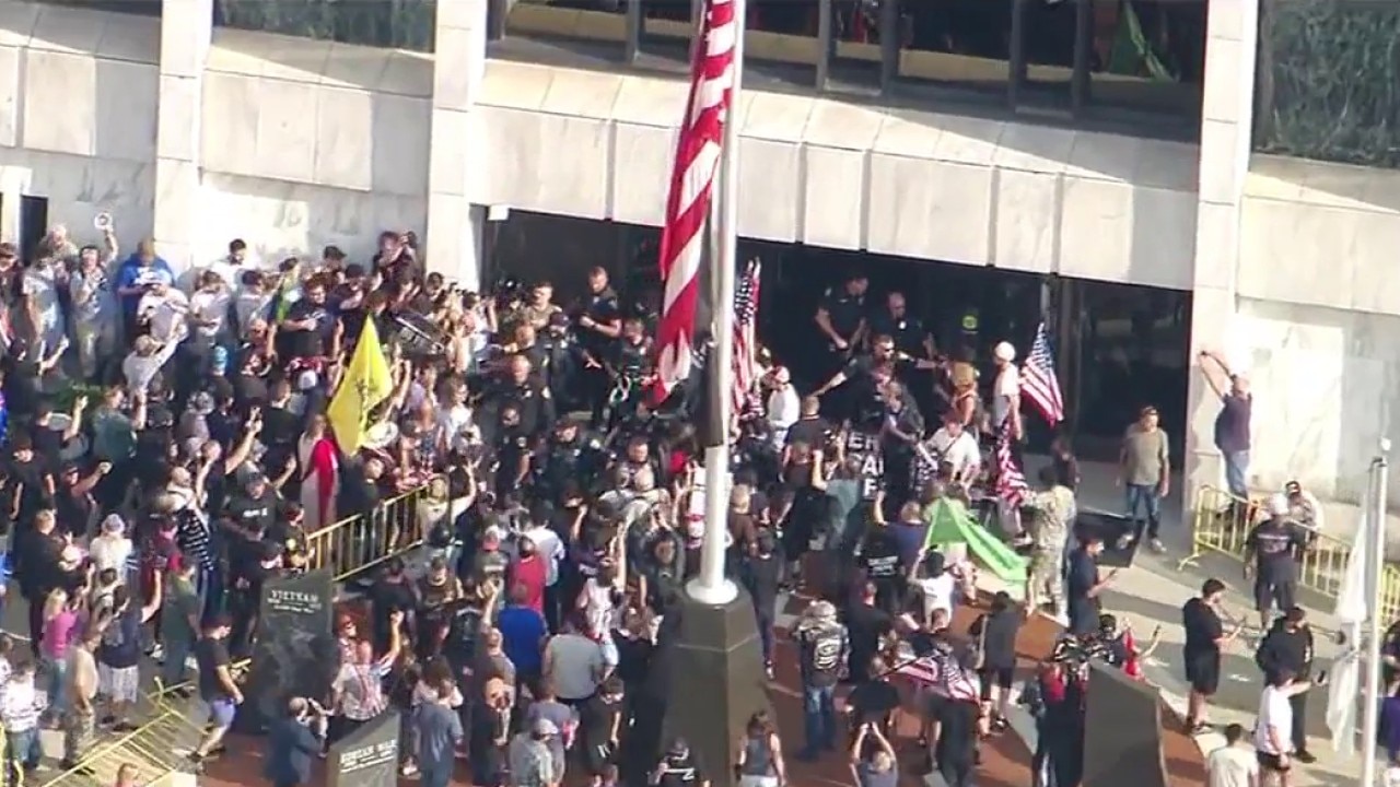 Demonstrators swarm City Council building as Jake Lang arrives