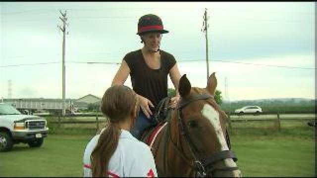 Laura prepares to play polo