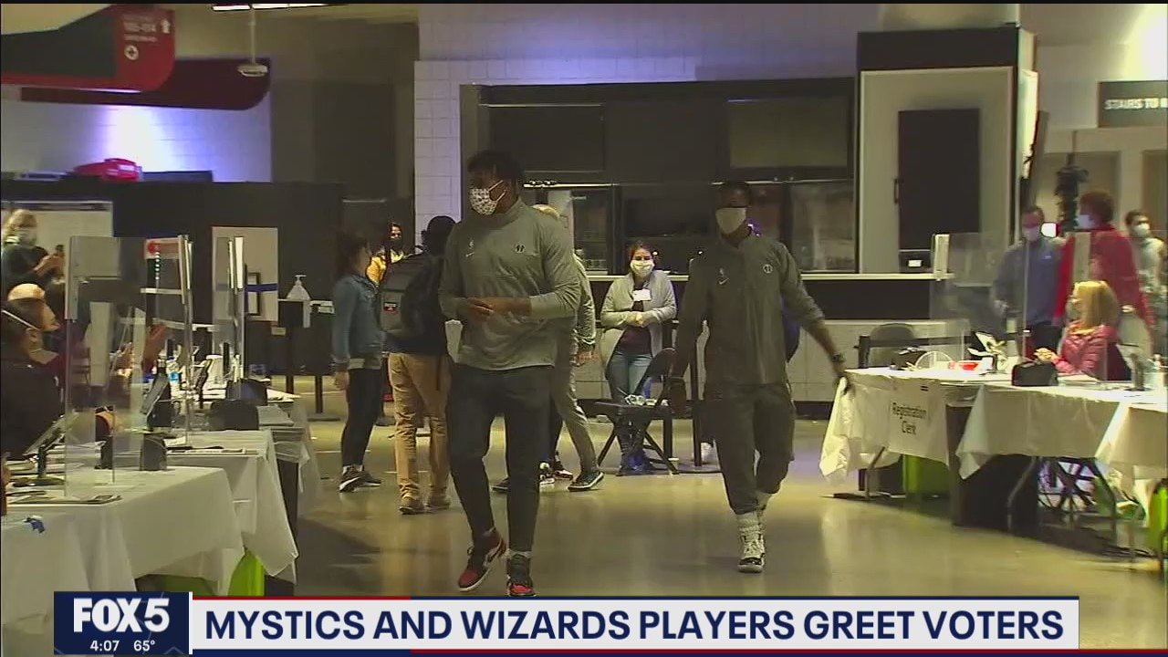 Mystics and Wizards players greet voters
