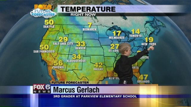Marcus Gerlach helps Meteorologist Rob Haswell with the weather