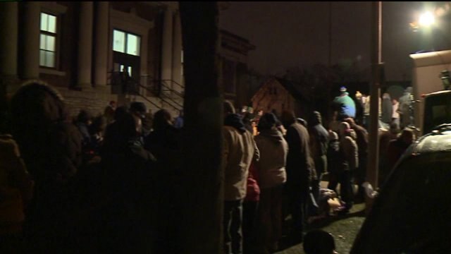 "It`s a busy night:" Volunteers spend Christmas Eve distributing winter gear to those in need