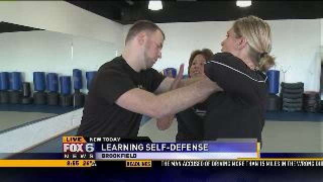 Laura learns how to defend herself against a front choke