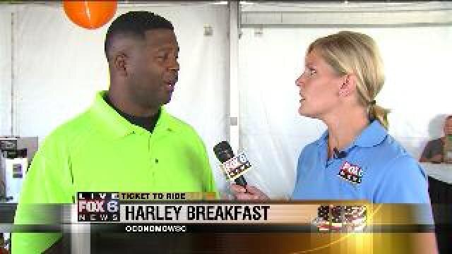 Laura talks with Leroy Butler at Harley breakfast
