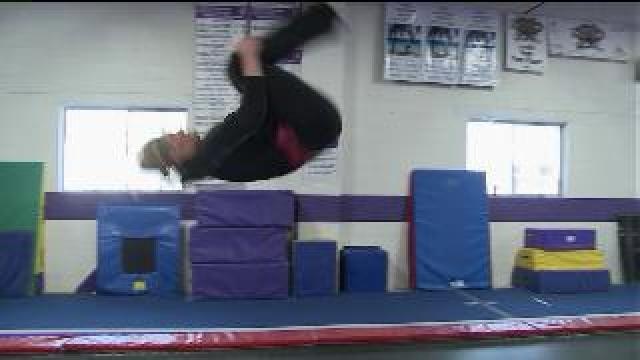 Laura does a front tuck at Wildcard Gymnastics