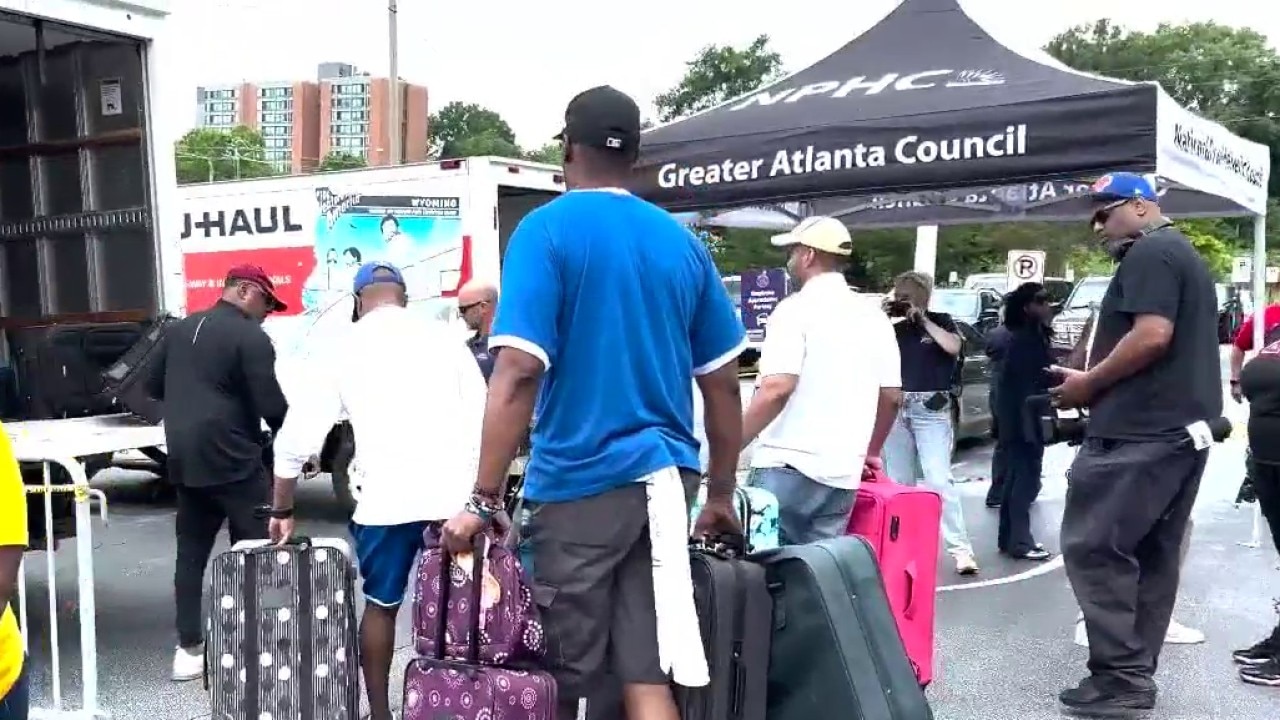 Volunteers collect donated luggage for foster care kids