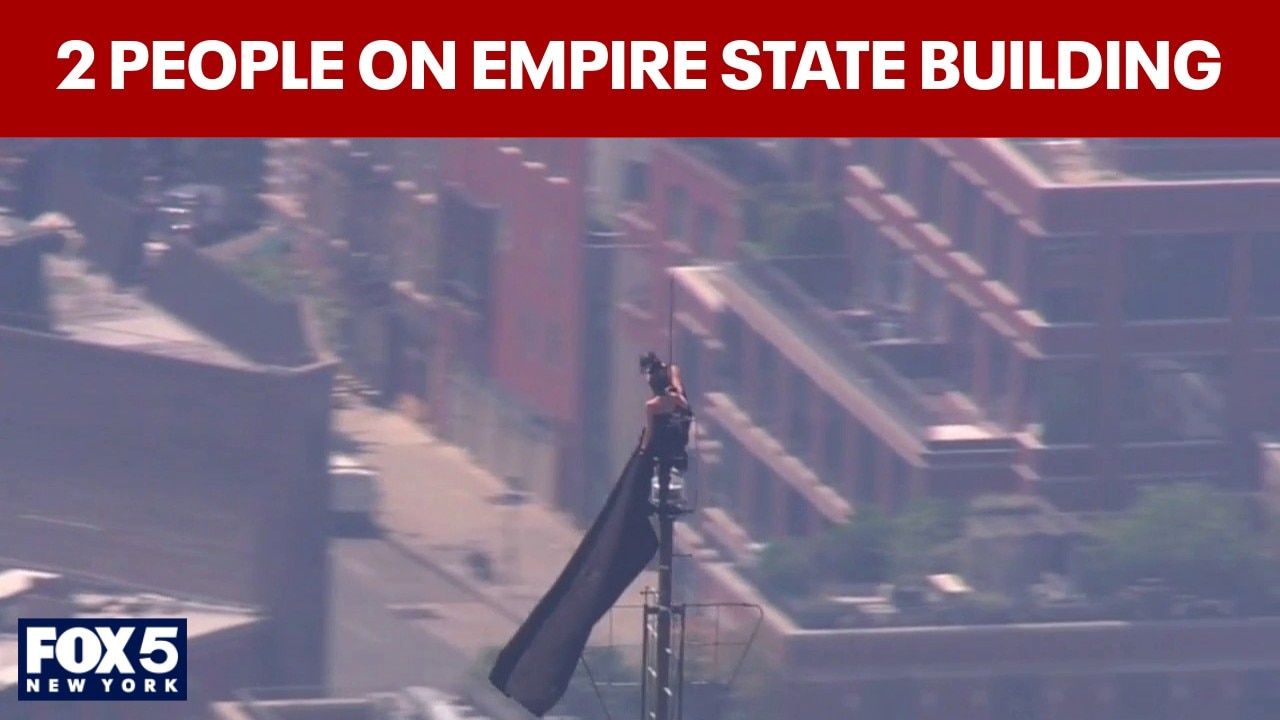 WATCH: 2 people climb to top of Empire State Building; raise flag from spire