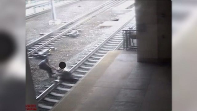 Officer pulls man from tracks just before train arrives