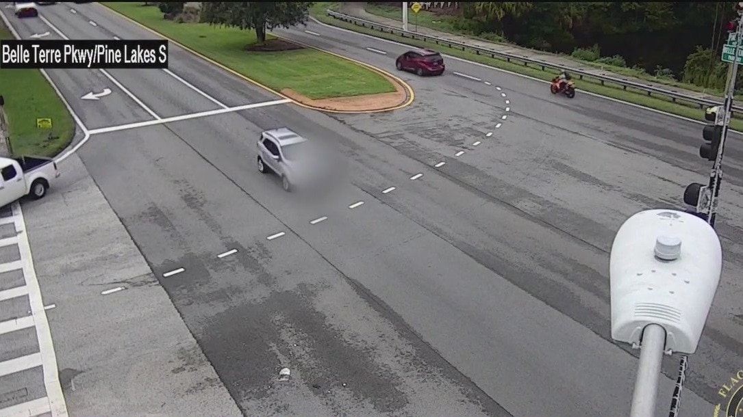 Across America: Person hangs onto car