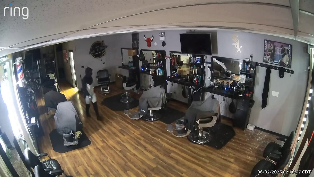 Video shows burglar breaking into Chicago barbershop