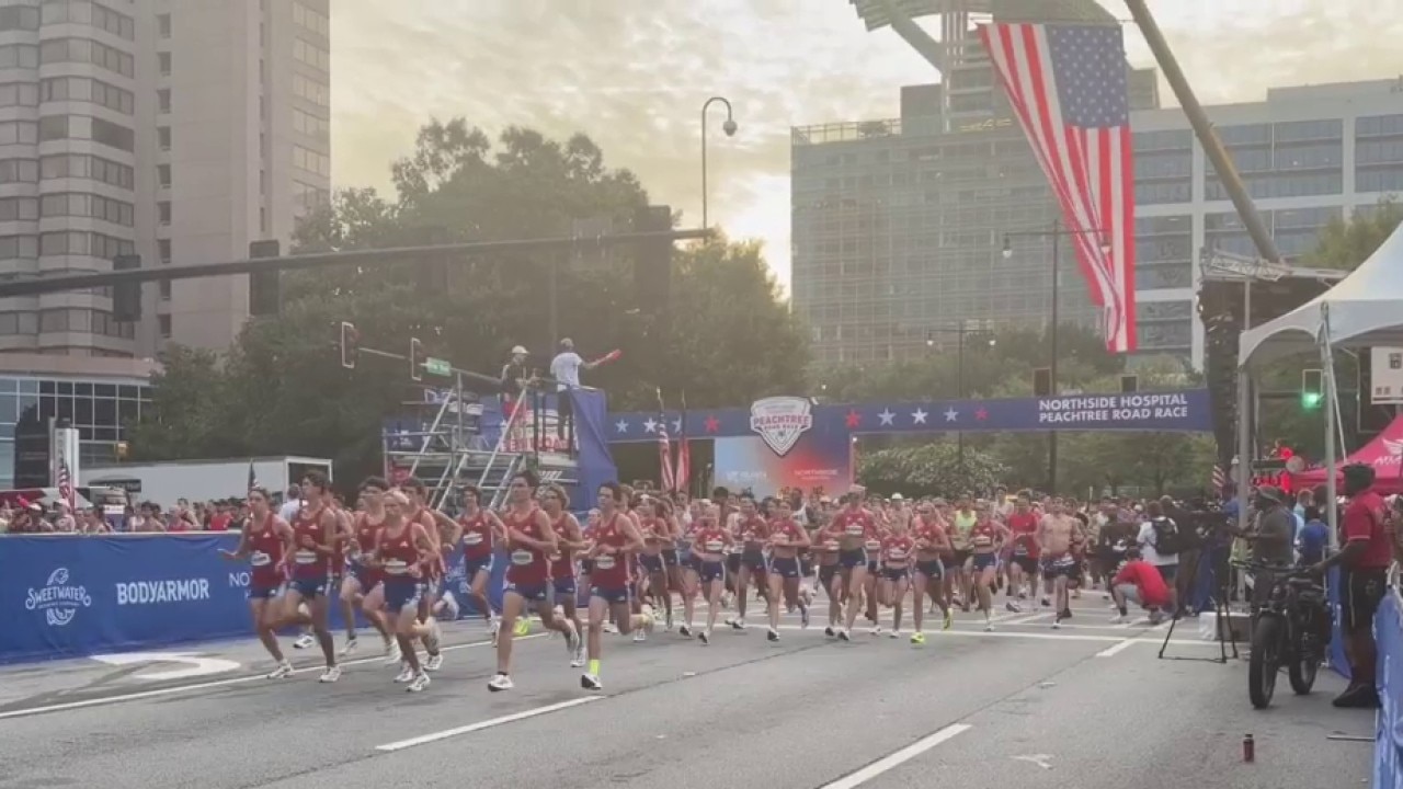 High school elites cross the start line of the Peachtree Road Race