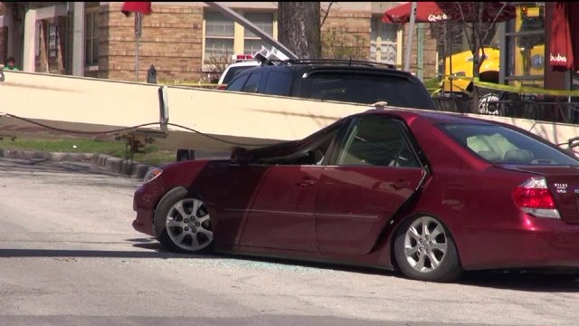 Crane overturns, crushing cars