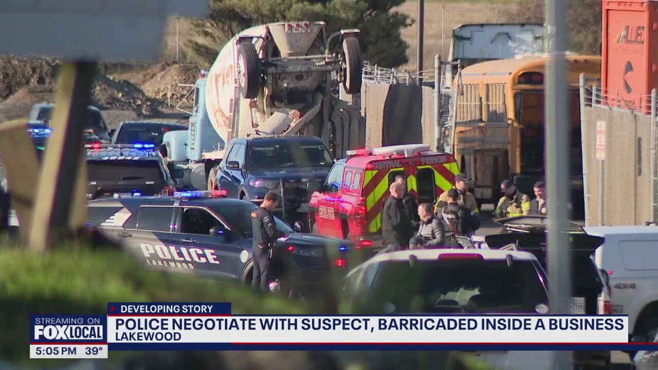 Police negotiate with suspect barricaded inside a business