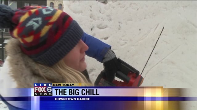 Laura learns the process of carving a snow sculpture