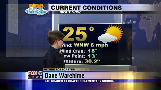 Dane Warehime helps Meteorologist Rob Haswell with the weather