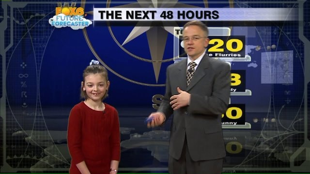 Madeline helps Meteorologist Rob Haswell with the weather