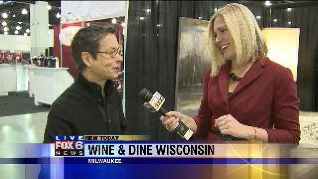 Laura learns about cookbook at Wine & Dine Wisconsin
