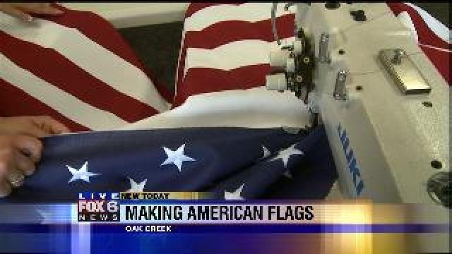 Laura learns how to stitch stripes on flags