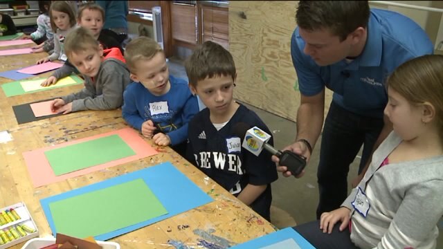 Chip talks with kids about their art projects