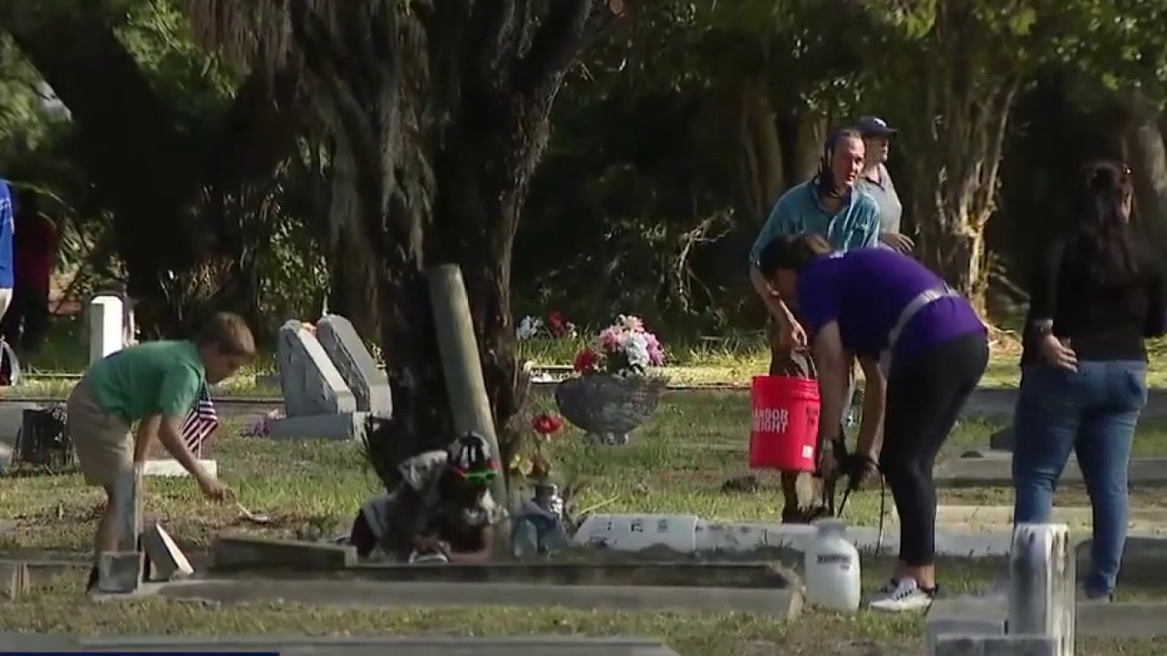 Community cleanup to restore vandalized cemetary