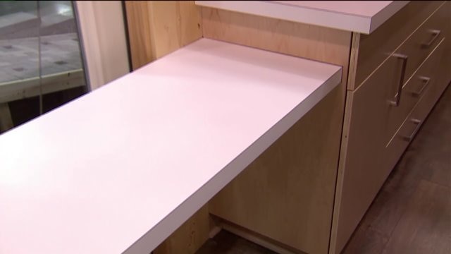 Kramp checks out the inside of a tiny home built in Oak Creek