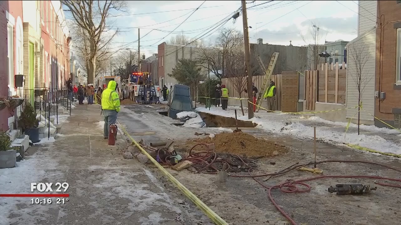 Water main break causes street to cave in, swallow 2 cars