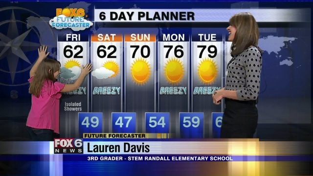 Lauren Davis helps Meteorologist Stephanie Barichello with the weather