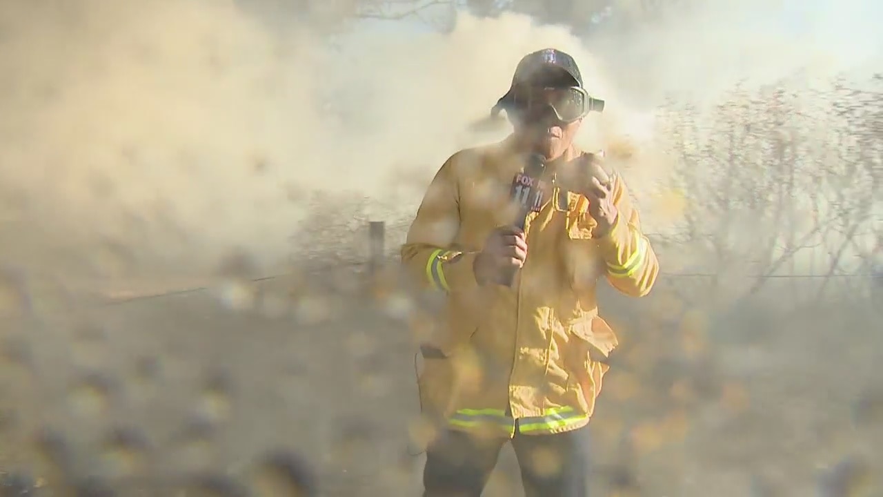 Bobby DeCastro gets watered on while reporting on 46 Fire