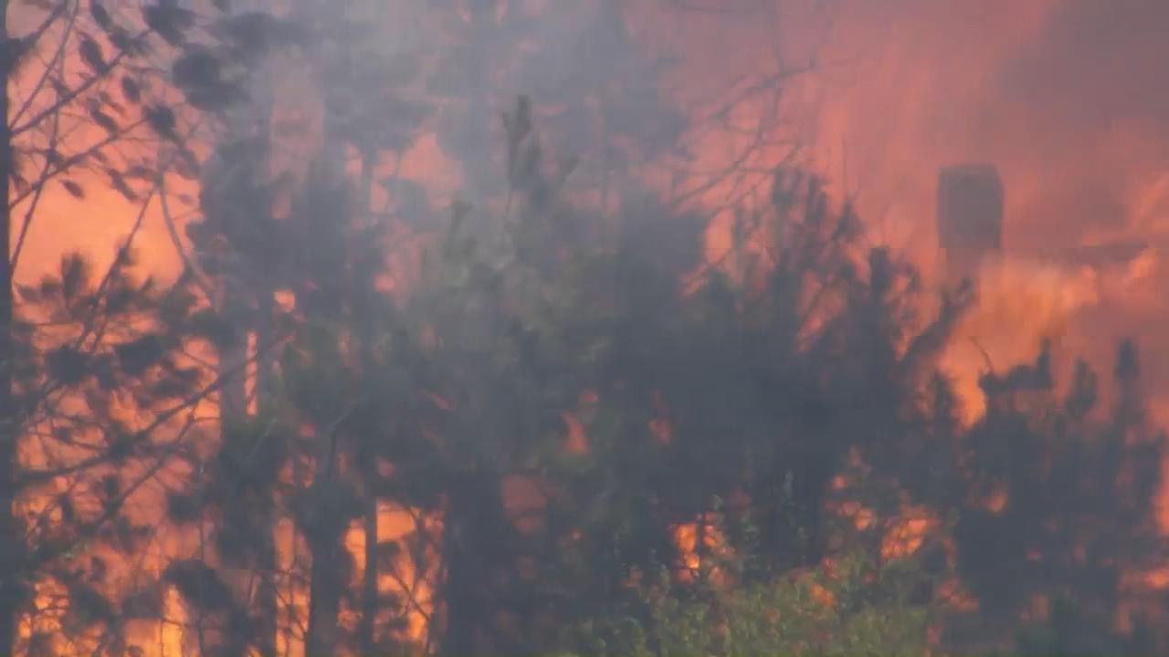 Fire crews work to control a large fire near Zebulon 