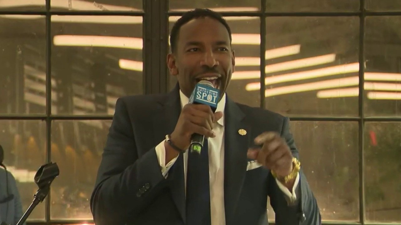 Mayor Andre Dickens stands alongside Ivory: 'Battle-tested'