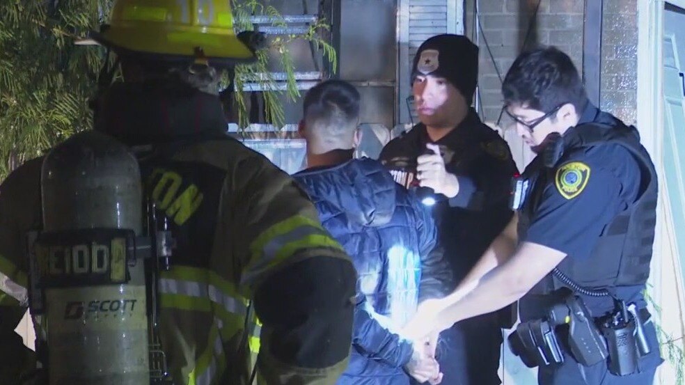 Man hospitalized and another man in custody following apartment fire