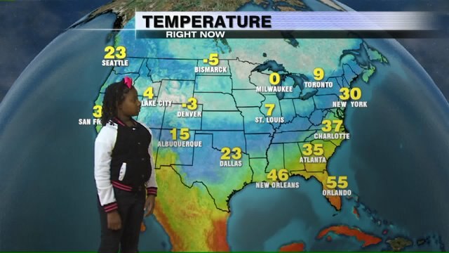 Janiyah helps Meteorologist Rob Haswell with the weather