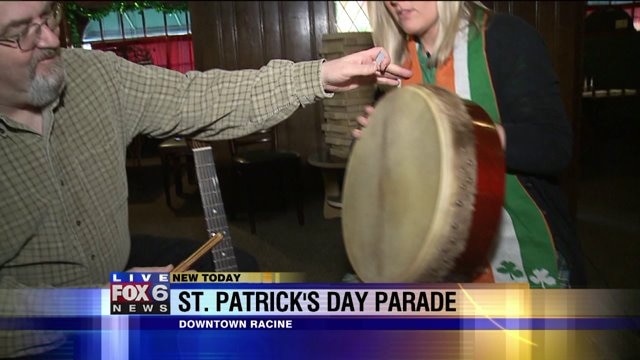 Laura learns how to play a drum as she enjoys Irish music