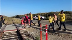 Watch: Rescue swimmers rush to the ocean to save two individuals