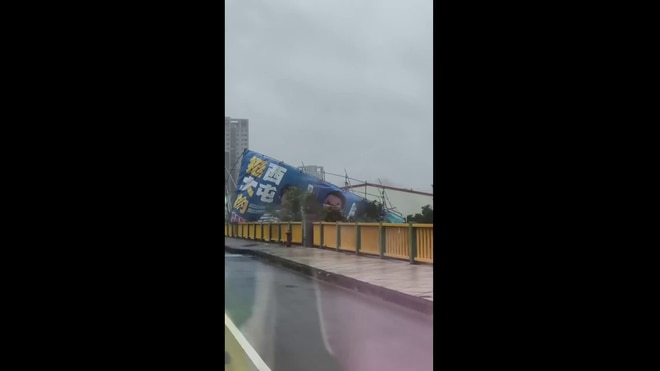 Signs whipped by wind as Typhoon Champi nears Taiwan