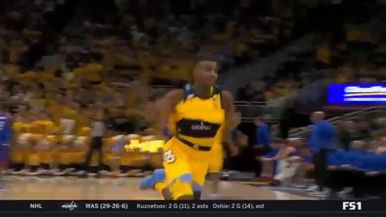 Kam Jones buries a deep three to give Marquette a 49-28 lead over DePaul at half